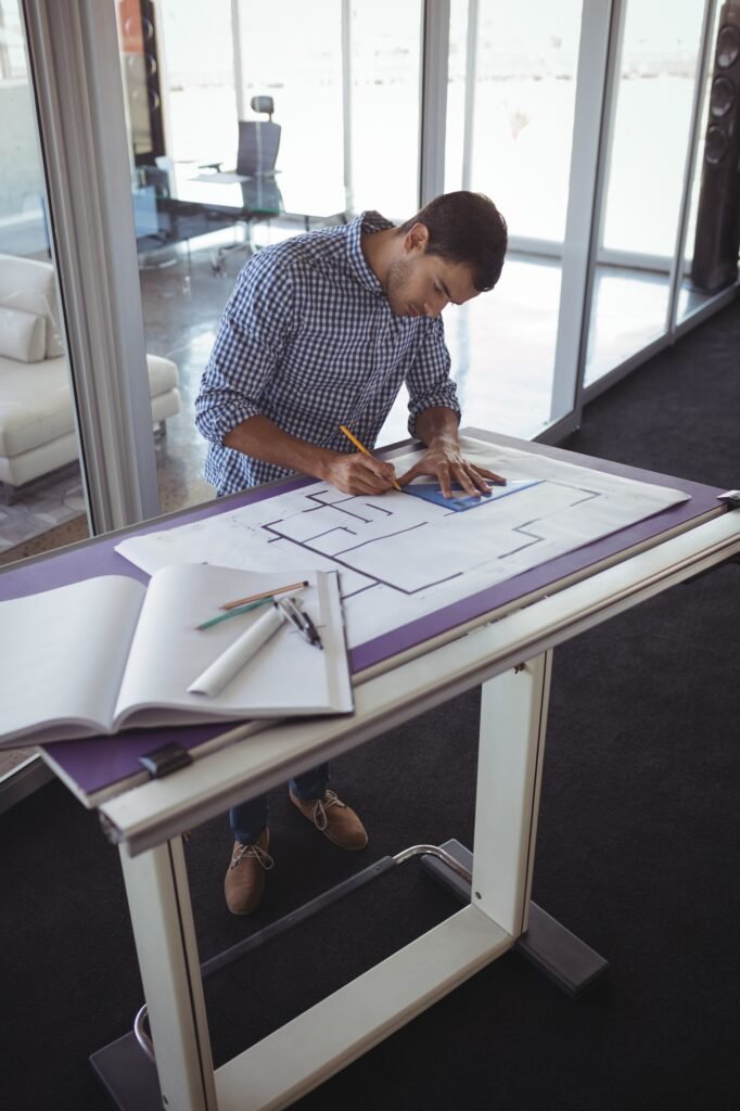 Focused interior designer planning on paper in creative office